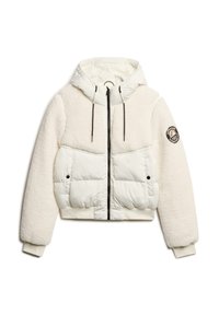 Veste matelassée blanche avec une silhouette courte. Présente une texture douce et pelucheuse sur les manches et le haut du corps, une capuche et des accents noirs sur la fermeture éclair.