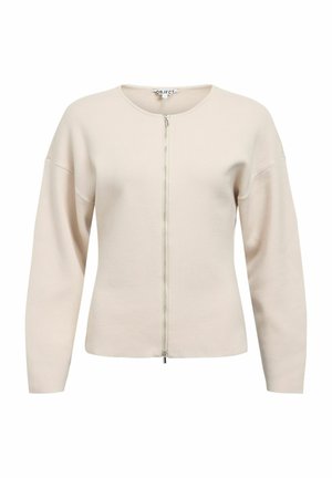 Jasnobeżowy kardigan na zamek z okrągłym dekoltem, opuszczonymi ramionami i miękką fakturą. Posiada srebrny zamek błyskawiczny i minimalistyczny design.