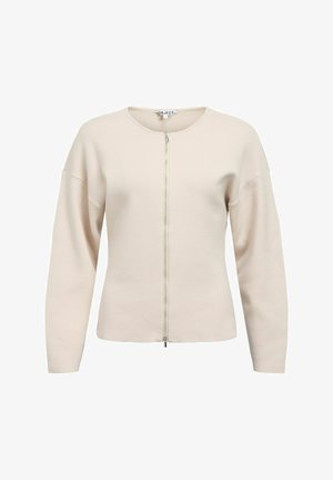 Jasnobeżowy kardigan na zamek z okrągłym dekoltem, opuszczonymi ramionami i miękką fakturą. Posiada srebrny zamek błyskawiczny i minimalistyczny design.