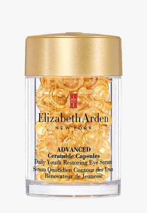 Gennemsigtig krukke med gyldent låg fyldt med gyldne ceramidkapsler mærket Elizabeth Arden Advanced Daily Youth Restoring Eye Serum.