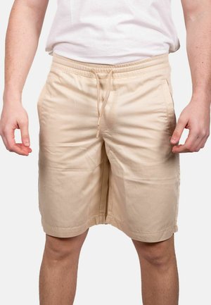 Pantaloni corti beige realizzati in tessuto leggero, con vita elastica e cordino. Presentano tasche laterali e un design snello.