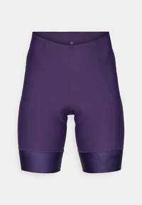 Lilla sykkelskjørt med en tettsittende design, som har en glatt tekstur, forsterkede sømmer og en mønstret nedre kant.