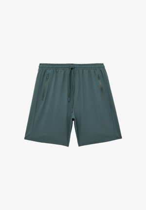 Donkergroene sportieve shorts met een elastische tailleband, een trekkoord en twee met rits gesloten zijzakken. Gladde, lichtgewicht stof met een ontspannen fit.