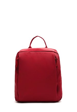 Red fabric backpack with a rectangular shape, front zipper pocket, and top handle. Smooth texture with no visible patterns or hardware.