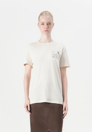 Crèmekleurig katoenen t-shirt met een grafische print op de linkerkant van de borst. Korte mouwen, ronde hals en een losse pasvorm.