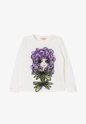 Camicia bianca a maniche lunghe con una grafica colorata di una donna con capelli ricci viola e accenti floreali verdi sul davanti.