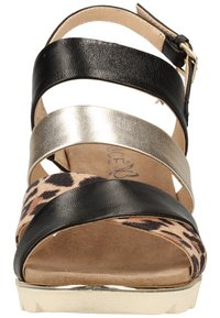 Strappy sandal featuring black, metallic gold, and leopard-print leather; open toe design with cushioned footbed and gold-accented sole.