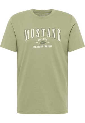 Green cotton t-shirt with short sleeves, featuring "MUSTANG CLASSICS" print in white on the front, round neckline, and relaxed fit.