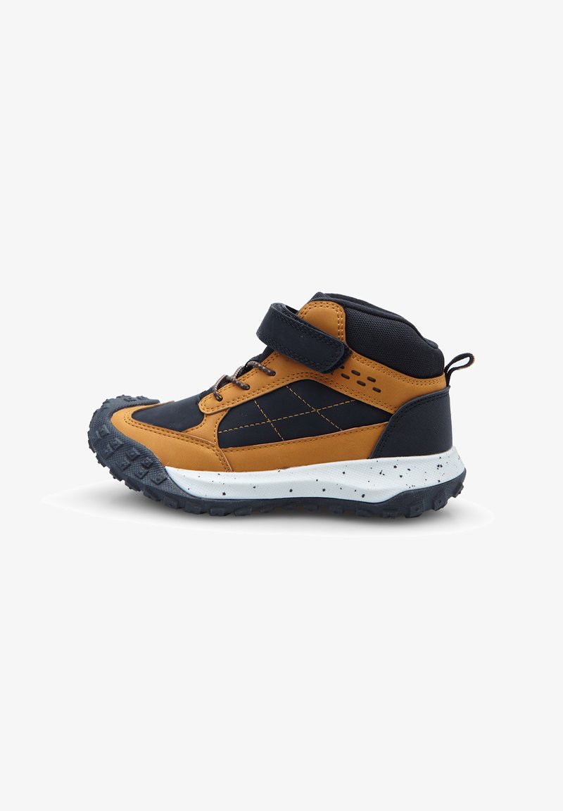 Scarpa alta marrone e nera con strap in Velcro, suola in gomma testurizzata, intersuola bianca e macchiata, e accenti con motivo a diamante.