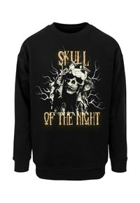 Sort sweatshirt med et stort grafisk tryk af et kranium med intrikate detaljer og teksten "SKULPEN AF NATTEN" i gult.