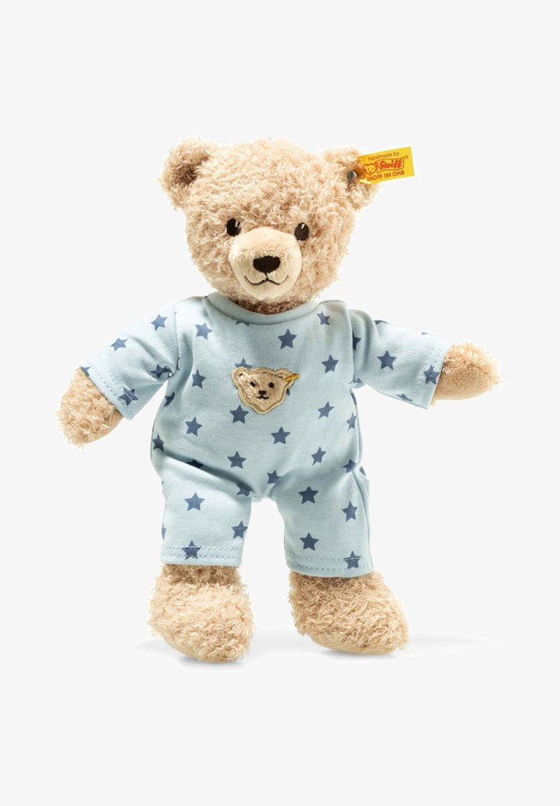 Stuffed bear with a fluffy beige coat, wearing light blue pajamas adorned with navy stars and a small embroidered bear face on the chest.