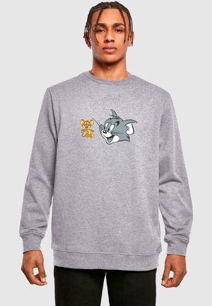 Light gray sweatshirt with long sleeves. Features a cartoon design of Tom and Jerry on the chest. Soft texture, casual fit.