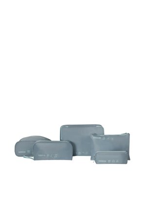 Five grey travel packing pouches of various sizes with white minimalist travel-related icons and zipper closures, arranged in a row.
