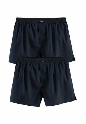 Two pairs of plain black elastic waist boxer shorts with front fly and small brand tags on the waistband.