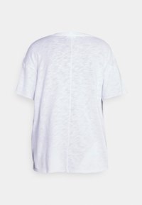 White short-sleeve t-shirt with a crew neckline, featuring a textured, slightly sheer fabric and a central seam down the back.