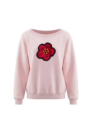Lyserød sweatshirt med lange ærmer med et stort rødt blomster-patch med gule prikker i midten på brystet.