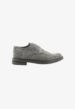Scarpe brogue in suede grigio con dettagli perforati, punta rotonda, suola piatta in gomma nera e design classico con lacci.