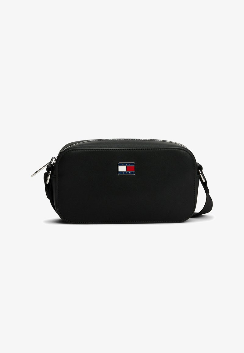 Black rectangular crossbody bag with zipper closure and small rectangular red, white, and blue logo plaque on front center.
