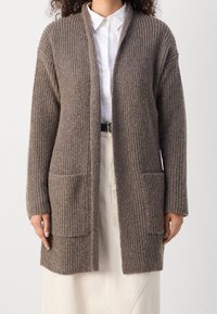 Brun ribbad cardigan med långa ärmar, två framfickor, öppen design, texturerad stickning och en avslappnad passform.