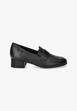 Mocassin en cuir noir à talon bas, avec un bout arrondi, des détails de couture et une petite étiquette sur le côté.