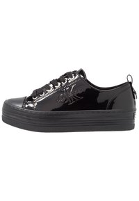 Black patent leather sneaker with a flat platform sole, textured black laces, and silver eyelets. Features a logo embossed on the side.