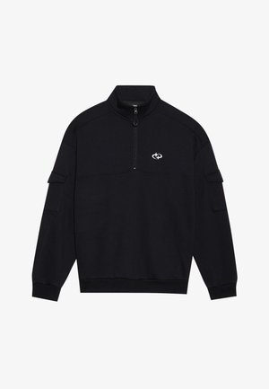 Musthave mustarjaga kõrge krae ja lukuga, mis on varustatud horisontaalse õmbluse detailide ja vasakule varrukale kinnitatud taskuga.