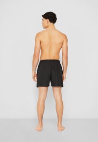 Calvin Klein Swimwear MEDIUM DRAWSTRING-GRAPHIC - Shorts da mare -  black