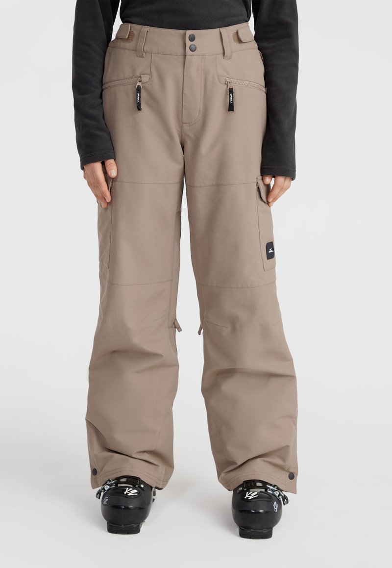 Beige ski pants with a relaxed fit, zippered pockets, and adjustable hem. Features a logo patch on the thigh and reinforced fabric.