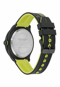 Czarny zegarek ze stalowym tyłem, z jasnobrązowym silikonowym paskiem i czarnymi akcentami, zaprojektowany z myślą o trwałości i sportowym stylu.