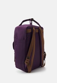 Purple fabric backpack with brown adjustable straps, side pocket, and top handle. Rectangular shape with a durable texture and subtle stitching.