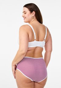 White bra with adjustable straps and hook closure, paired with high-waisted red and white striped briefs featuring a smooth texture and contrasting trim.