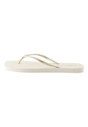 Einzelne beige Flip-Flop-Sandale mit dünnen Riemen und strukturiertem Fußbett in Seitenansicht vor weißem Hintergrund.