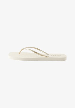 Einzelne beige Flip-Flop-Sandale mit dünnen Riemen und strukturiertem Fußbett in Seitenansicht vor weißem Hintergrund.