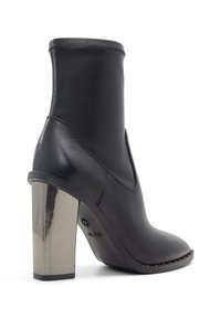 Black leather ankle boot with a shiny metallic heel. Sleek design, pointed toe, stitched upper, and a smooth texture.