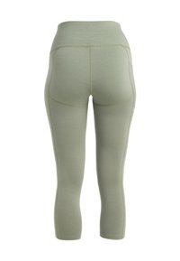 Lysegrønne, strækbare leggings med høj talje. Har en glat tekstur og buede søm detaljer, designet til komfort og fleksibilitet.