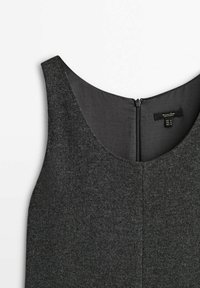 Robe grise sans manches en tissu texturé, avec un col arrondi et une fermeture éclair centrale à l'arrière. Étiquette visible à l'intérieur.