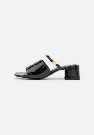 Black patent leather block-heel sandals with an open toe design. Features a slender ankle strap and a gold-toned buckle detail.