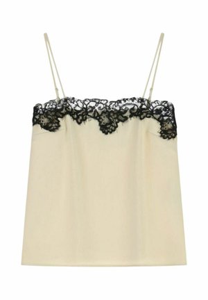 Top in cotone beige con spalline sottili, caratterizzato da un bordo in pizzo nero lungo il scollatura e l'orlo superiore. Tessuto morbido e liscio senza decorazioni visibili.