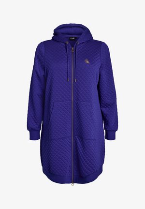 Quilted long purple hoodie with front zipper, drawstring hood, two front pockets, ribbed cuffs, and a small logo on the chest.