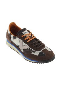 Brown and white suede sneaker with cow print, orange laces, and a blue accent on the sole. Classic design with patterned details.