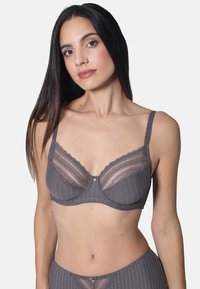 Gray bra with lace trim and pinstripe design. Features a decorative center between cups and adjustable straps. Soft texture and structured shape.