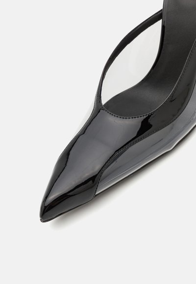 Black patent leather pump with pointed toe, transparent side panels, and sleek silhouette. Glossy finish enhances the modern design.