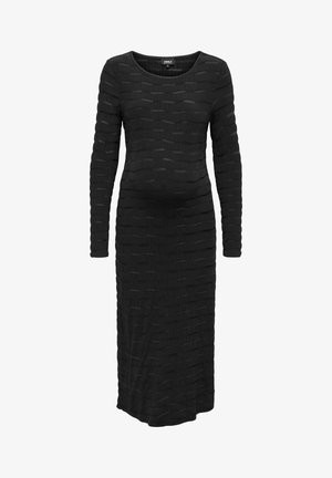 Zwart lange mouwen jurk met een geaccentueerd ontwerp met golvende patronen, knie-lange snit en ronde halslijn. Gemaakt van een zachte, rekbare stof.