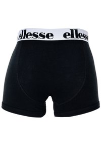 Pantaloni boxer neri con una cintura elastica bianca che presenta il logo "ellesse". Realizzati in un tessuto morbido e elasticizzato per garantire comfort.