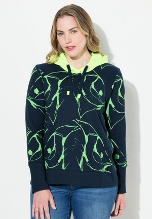 Haut à capuche bleu marine avec des motifs abstraits en vert fluo, capuche à cordon de serrage, poignets et ourlet côtelés, fabriqué dans un tissu doux et texturé.