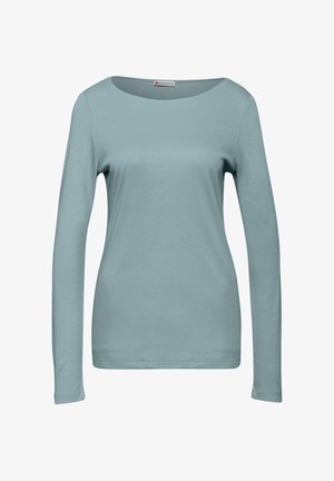 Camicia a maniche lunghe blu chiaro da donna con scollo rotondo, mostrata su uno sfondo bianco semplice.