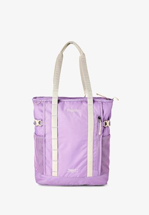 Sac fourre-tout lavande avec de longues poignées beiges, poche zippée frontale, poches latérales en mesh, et logos de la marque "Haglöfs" et "TIGHT".