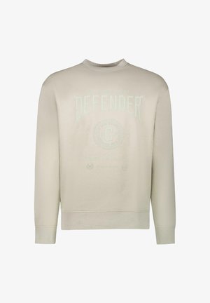 Beige sweatshirt, ronde hals, met reliëftekst "DEFENDER" en circulair logo-detail op de borst. Zachte katoenmix materiaal, geribde manchetten.
