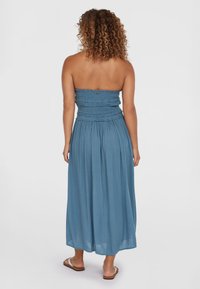 Schulterfreies blaues Maxikleid mit gerafftem Oberteil und fließendem Rock, aus leichtem Stoff. Mit geradem Ausschnitt und geknöpftem Textur.