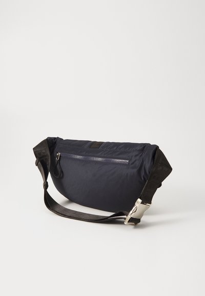 Navy nylon bag with a rectangular shape, zippered pocket, and detachable strap. Features a silver buckle and textured strap accents.